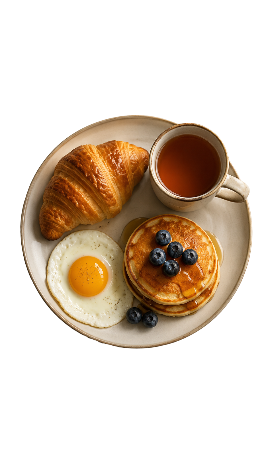 A plate of tea, a croissant, an egg, and two pancakes.
